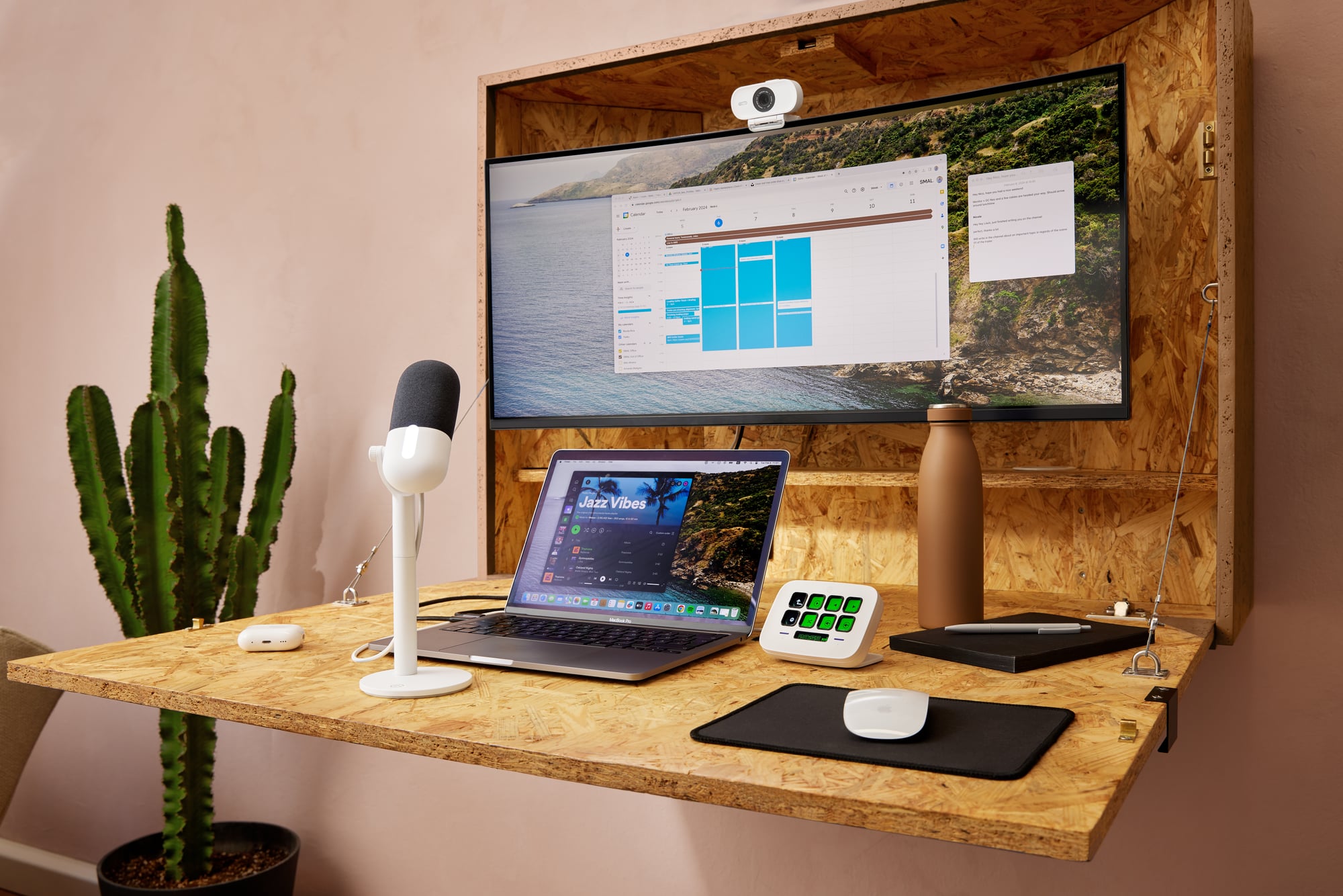 A person on a video call at a professional desk with a Stream Deck Neo beside the keyboard — mute, camera, and meeting controls visible on the keys.